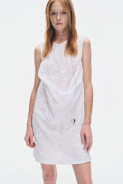 Model back angle wearing YIBRI White Sculpted Crinkle Mini Dress featuring keyhole closure and crinkle-textured minimalist silhouette