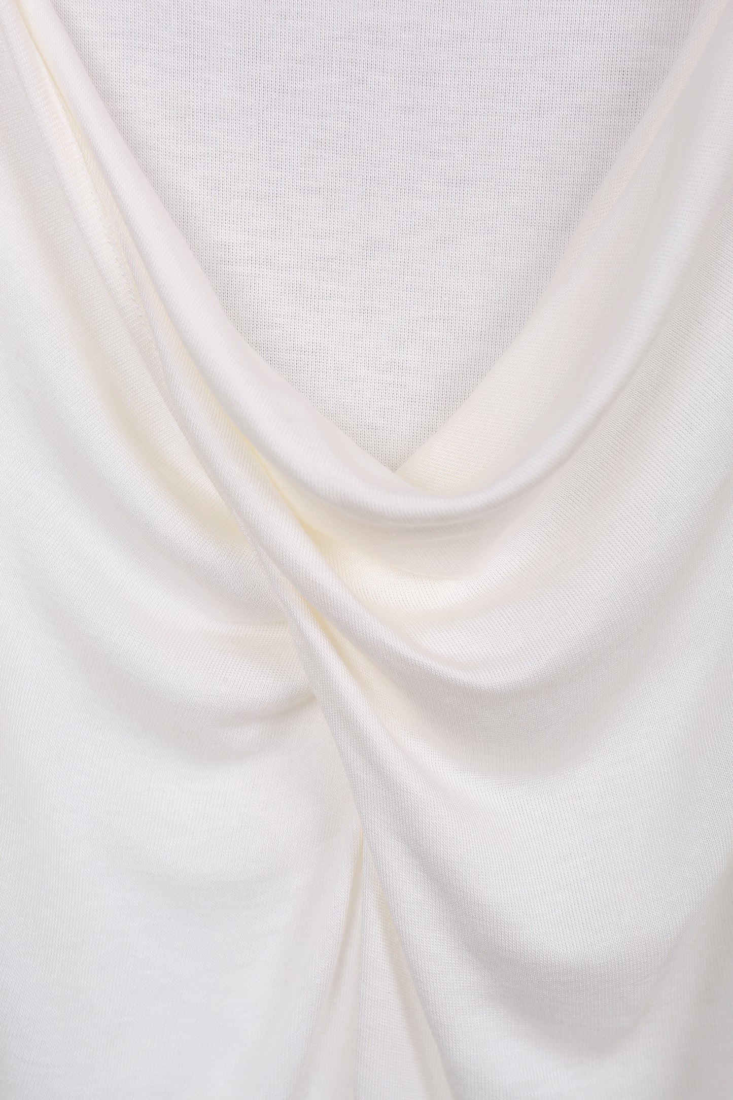 Detail close-up of the twisted neckline on the YIBRI White Twisted Long Jersey Sleeve Top, showing the draped jersey folds.