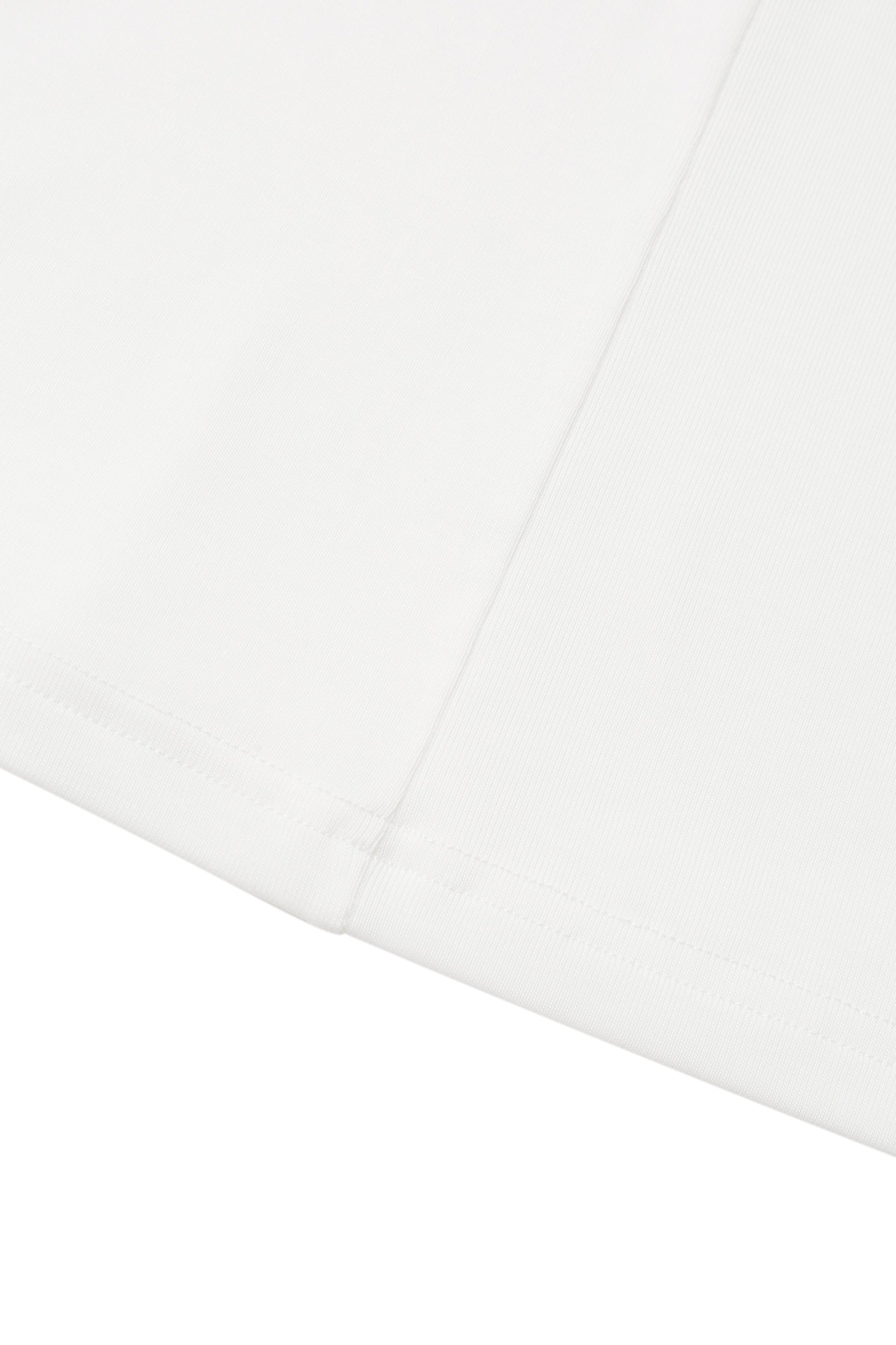 Close-up of the hem on the YIBRI White Twisted Long Jersey Sleeve Top, highlighting the fine jersey stitching and subtle ivory tone.