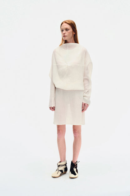 Side view of model wearing the YIBRI White Wrinkle-Textured Reversible Top, highlighting the draped batwing sleeve and relaxed fit.