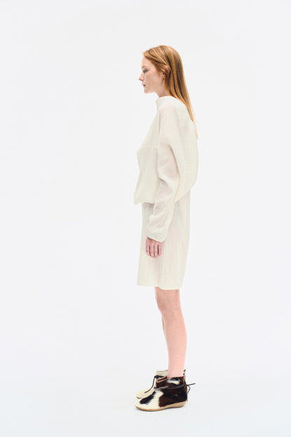 Angled front view of the YIBRI White Wrinkle-Textured Reversible Top, showing the soft volume and architectural shape.