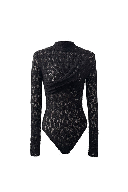Front view of YIBRI Reversible Twisted-Knot Top in black lace, featuring a sculptural twisted panel across the chest and long sleeves in sheer floral lace.