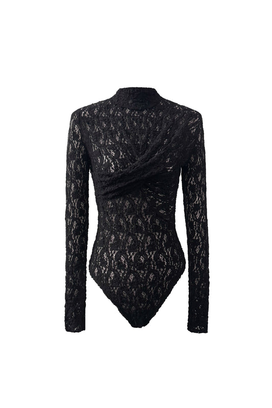 Front view of YIBRI Reversible Twisted-Knot Top in black lace, featuring a sculptural twisted panel across the chest and long sleeves in sheer floral lace.